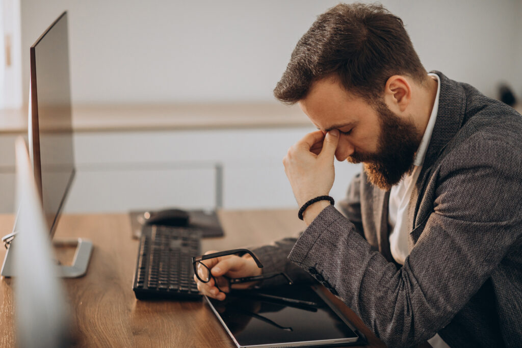 Stressed and depressed worker at their computer