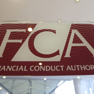 A logo sits on a sign in the reception area of the headquarters of the Financial Conduct Authority (FCA) in the Canary Wharf business district in London, U.K., on Thursday, Nov. 21, 2013. The FCA is working with regulators including the U.S. Department of Justice and the Commodity Futures Trading Commission to investigate the potential manipulation of the foreign-exchange market. Photographer: Chris Ratcliffe/Bloomberg