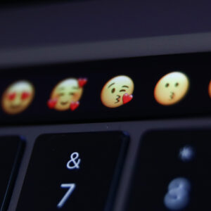 Emojis are seen displayed on MacBook Pro touchbar in this illustration photo taken in Krakow, Poland on April 13, 2022. (Photo Illustration by Jakub Porzycki/NurPhoto via Getty Images)