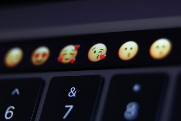 Emojis are seen displayed on MacBook Pro touchbar in this illustration photo taken in Krakow, Poland on April 13, 2022. (Photo Illustration by Jakub Porzycki/NurPhoto via Getty Images)